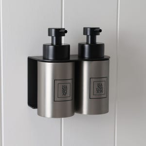 May include: A set of three ceramic mugs with a speckled, matte finish. The mugs are in shades of cream, light gray, and dark gray. Each mug has a simple, minimalist design, perfect for coffee or tea.