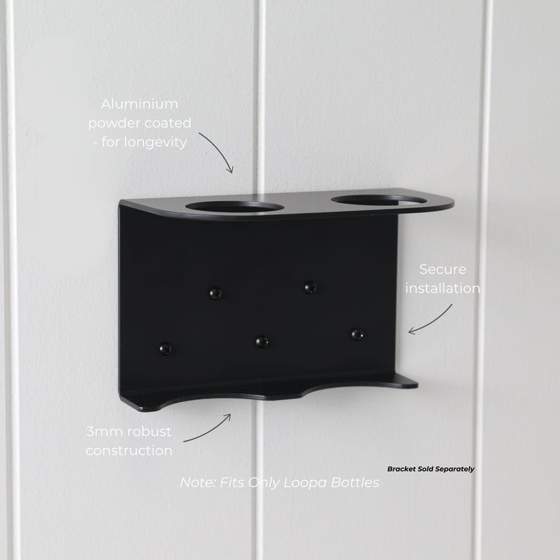 May include: A black, powder-coated aluminum bracket designed to hold two bottles. The bracket features a robust 3mm construction and is designed for secure installation. The text on the image says "Note: Fits Only Loopa Bottles."
