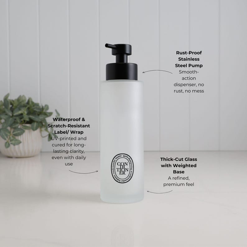 Feature-led image of frosted glass conditioner dispenser highlighting premium build and everyday usability. Showcases smooth rust-resistant pump, durable waterproof UV printed label, and thick weighted base for stability. Refillable bathroom bottle designed for clean dispensing, long-lasting performance, and a refined minimalist look.
