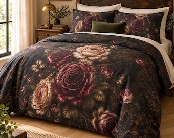 May include: A bedding set featuring a dark charcoal background with a large-scale floral print of deep burgundy, cream, and muted pink roses. The set includes a duvet cover and two matching pillow shams, accented by a small, solid olive green pillow.