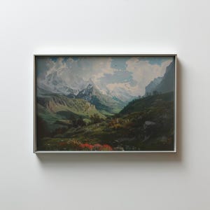 Puede incluir: Pintura de paisaje enmarcada que representa un valle de montaña. La obra presenta montañas nevadas, colinas verdes y un valle con un río. El cielo es azul con nubes blancas, y la pintura está en un marco plateado.
