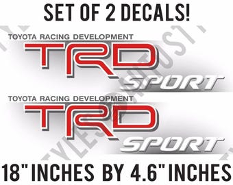 May include: Set of two 18 inch by 4.6 inch decals featuring the Toyota Racing Development logo in red and gray with the word "Sport" in gray.
