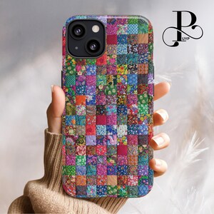 May include: A colorful phone case with a patchwork design. The case is made up of many small squares of different fabrics, each with a unique pattern. The case is designed to fit an iPhone.