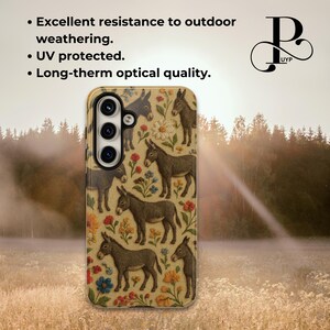 May include: A phone case with a brown background and a pattern of donkeys and flowers. The case has a camera lens cutout and is designed to fit a smartphone.