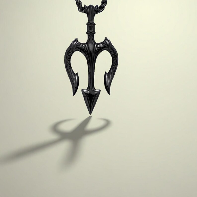 May include: A black trident pendant necklace. The pendant, suspended from a chain, has a central spearhead and curved prongs. The design casts a shadow. The necklace is a dark, gothic style.