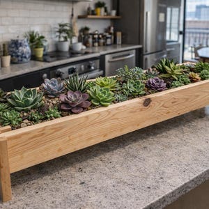 May include: A rectangular wooden planter box filled with various succulents. The box is made of light-colored wood and sits on four short legs. The succulents are a mix of green, purple, and blue-green hues, arranged in a decorative display.