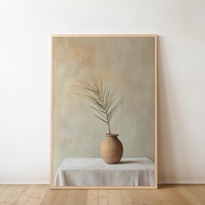 May include: A painting of a single green branch in a terracotta vase on a white tablecloth. The background is a muted green and brown.