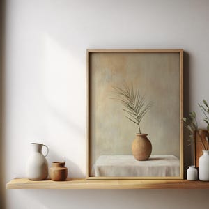 May include: A framed painting of a single branch with leaves in a terracotta vase on a white tablecloth. The painting is on a wooden shelf with a white pitcher, a small brown jar, and a white vase with a small green plant.