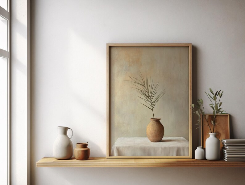 May include: A framed painting of a single branch with leaves in a terracotta vase on a white tablecloth. The painting is on a wooden shelf with a white pitcher, a small brown jar, and a white vase with a small green plant.