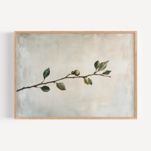 May include: A framed botanical print featuring a branch with green leaves and two small, round, green fruits. The branch is set against a neutral, textured background with a light wooden frame.