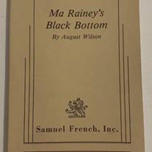 May include: A vintage book cover for "Ma Rainey's Black Bottom" by August Wilson. The cover is tan with black text and a small illustration. The publisher's name, Samuel French, Inc., is also printed on the cover.