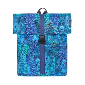 May include: A roll-top backpack with a vibrant peacock feather pattern in shades of blue and teal. The bag features a navy blue strap with a black buckle closure and a small black handle at the top.