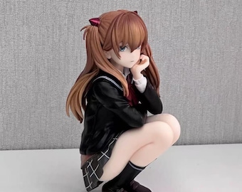 May include: A figurine of a young person with long, auburn hair styled in pigtails, wearing a black school uniform with a white collared shirt and a plaid skirt. The figure is in a squatting position, with a thoughtful expression.