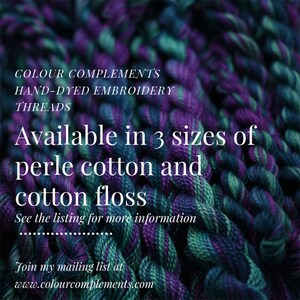 May include: Close-up of hand-dyed embroidery threads in shades of purple, teal, and green. The image includes text that reads "COLOUR COMPLEMENTS HAND-DYED EMBROIDERY THREADS" and "Available in 3 sizes of perle cotton and cotton floss."