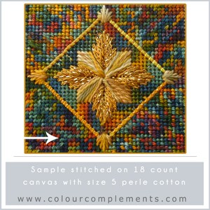 May include: Close-up of a cross-stitch design featuring a gold starburst on a colorful background. The design is stitched on 18 count canvas with size 5 perle cotton. The text "www.colourcomplements.com" is visible below the design.
