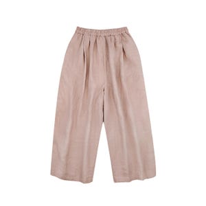 May include: A pair of wide-leg, cropped pants in a muted rose color. The pants have a gathered waistband and pleats at the front, creating a relaxed fit. The fabric appears to be a lightweight linen or similar material.