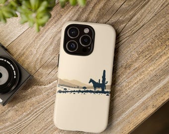 May include: A cream-coloured smartphone case featuring a dark blue silhouette graphic of a horse standing next to a tall cactus in a desert landscape. The design includes layered tan and beige horizontal bands representing distant hills and terrain.