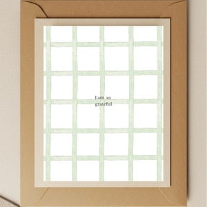 May include: A white card with a green grid pattern and the text "I am so grateful" in the center.