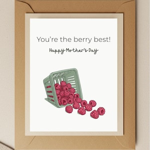 May include: A white card with the text "You're the berry best! Happy Mother's Day" and a green basket overflowing with red raspberries.