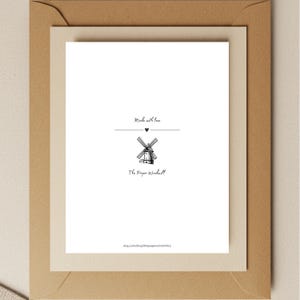 May include: A white card with black text that reads "Made with love" and a small black heart symbol. Below the text is a black and white illustration of a windmill. Below the windmill is the text "The Paper Windmill" and the website address "etsy.com/shop/thepaperwindmillco".