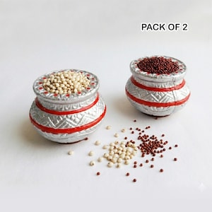 May include: Two silver-colored pots with red accents, filled with grains. One pot contains white grains, the other contains brown grains. The image is labeled "PACK OF 2".