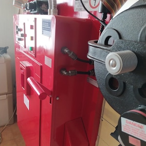 May include: A red metal electrical panel with a black handle and a warning sign that reads "DANGER ELECTRICAL EQUIPMENT AUTHORIZED PERSONNEL ONLY".