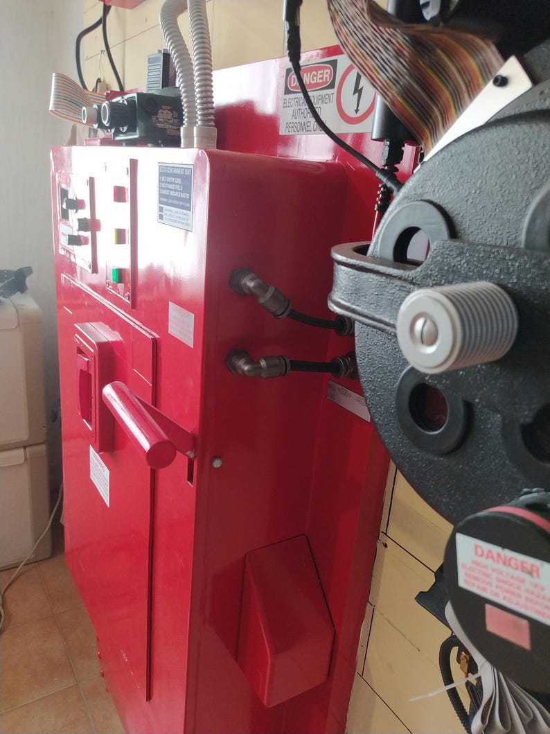 May include: A red metal electrical panel with a black handle and a warning sign that reads "DANGER ELECTRICAL EQUIPMENT AUTHORIZED PERSONNEL ONLY".