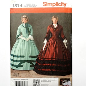 May include: A Simplicity sewing pattern envelope 1818 U5 featuring two historical-style dresses. One is light green with dark green trim, and the other is deep red with black ruffled trim. Both include white collars and long sleeves.