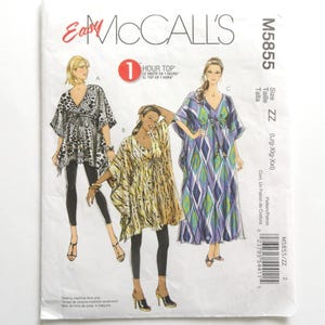 May include: McCall's sewing pattern M5855 for a one-hour top. The pattern features three different top designs, including a V-neck top with a black and white animal print, a yellow and gold patterned top, and a blue and green geometric print top.