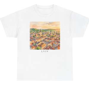 May include: A white short-sleeve t-shirt featuring a square watercolor illustration of a cityscape with church spires and terracotta rooftops under a warm sky. The text LVIV is printed in black capital letters centered below the illustration.