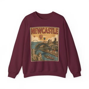 Nostalgic travel art printed on a sand sweatshirt highlighting the scenic Newcastle quayside in retro-style colors.