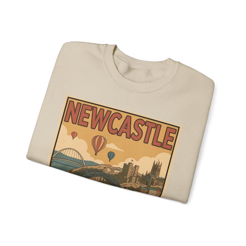 Close-up of a mid-century style sweatshirt design featuring the word NEWCASTLE in bold red vintage typography.
