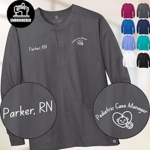 May include: A dark gray long-sleeve medical scrub jacket with the embroidered text "Parker, RN" and "Pediatric Case Manager". The jacket has a round neck and two pockets. Additional color options are displayed.