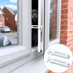 May include: A white plastic window restrictor latch installed on a white window frame, with a grey cat visible through the opening. A circular inset shows two identical white plastic window restrictor latches isolated against a white background.