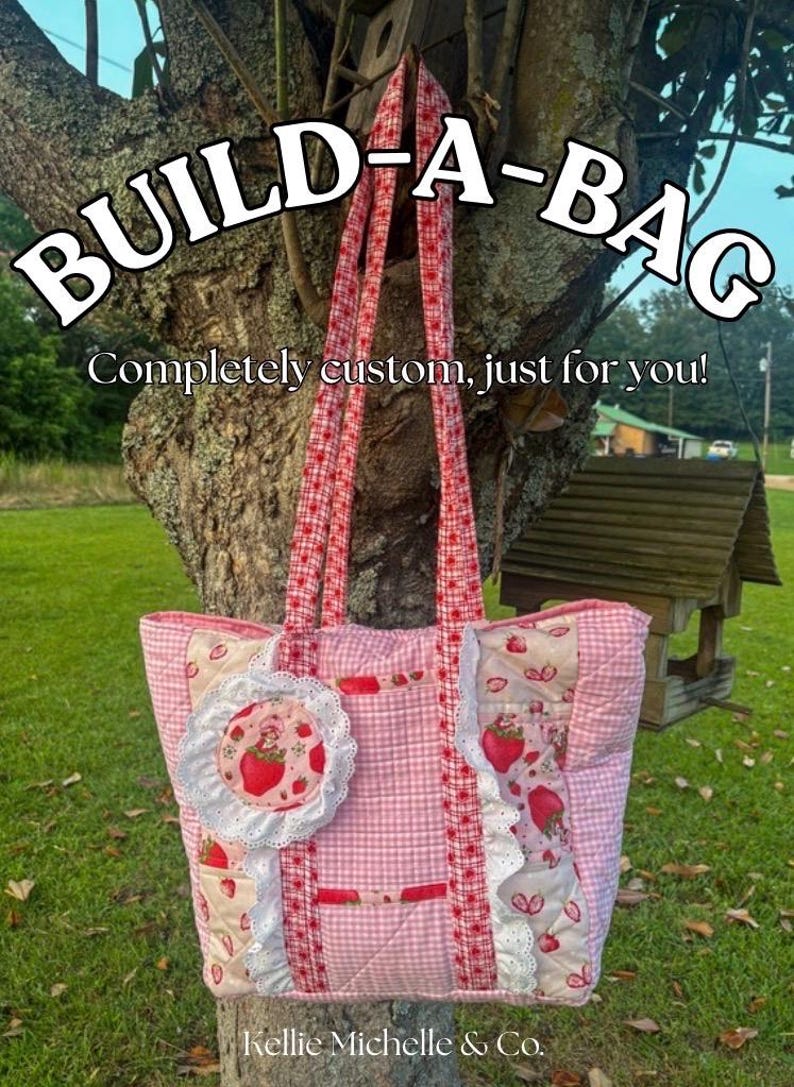 May include: Pink and white quilted tote bag with strawberry accents and red gingham straps. The bag features the text "BUILD-A-BAG" and "Completely custom, just for you!"