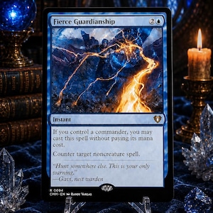May include: A Magic: The Gathering trading card titled Fierce Guardianship. The card features blue and orange artwork of a figure casting a spell, with text detailing the instant spell mechanics, mana cost, and the quote: Hunt somewhere else. This is your only warning. —Gavi, nest warden.