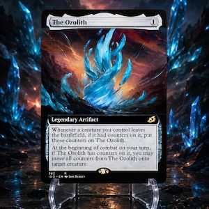 May include: A Magic: The Gathering trading card titled The Ozolith, featuring a vibrant blue crystalline structure against a dark, fiery landscape. The card text describes the Legendary Artifact's ability to store and move counters between creatures.