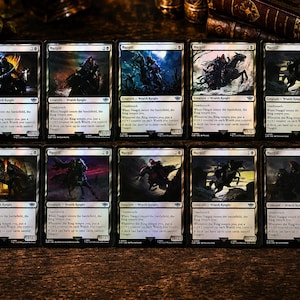 May include: A collection of ten Nazgûl trading cards from the Magic: The Gathering set. Each card features unique dark fantasy artwork of a cloaked rider on horseback, white borders, and text detailing the creature type as a Wraith Knight.
