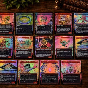 May include: A collection of fourteen Magic: The Gathering trading cards arranged in three rows on a dark wooden surface. Each card features vibrant, colorful goblin-themed artwork with black borders, detailed text, and distinct game statistics.