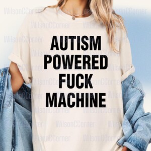 A person wearing a white t-shirt with the text "Autismpowered fuck machine" printed on it.