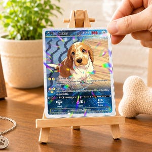 May include: A rectangular trading card featuring a brown and white spaniel puppy illustration with the text PET: Tucker, 260 HP, and various game statistics. The card has a holographic finish with rainbow light reflections and a dark blue starry base.