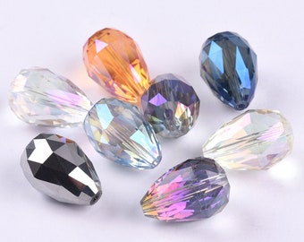 May include: Assortment of teardrop-shaped crystal beads in various colors, including clear, iridescent, blue, purple, and orange. The beads are faceted and have a shiny finish.