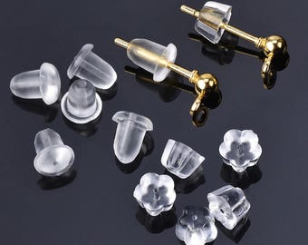 May include: A set of clear plastic earring backs in various shapes and sizes, including round, flower, and teardrop shapes. The backs are designed to secure earrings to the earlobe.