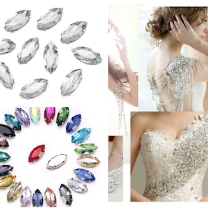 May include: Assortment of clear and colored marquise-shaped rhinestones. The rhinestones are shown in a circle with the clear rhinestones on the top and the colored rhinestones on the bottom. The rhinestones are also shown on a white dress, which is decorated with rhinestones.
