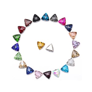 May include: Assortment of triangle-shaped rhinestones in various colors, including red, blue, green, purple, pink, and gold. The rhinestones are arranged in a circle around a silver setting.
