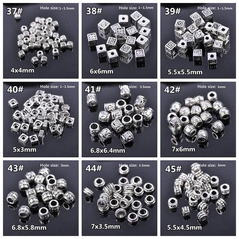 May include: Assortment of silver metal beads with various sizes and designs. The beads are arranged in rows with their size and hole size labelled. The beads are perfect for jewellery making, crafts, and other DIY projects.