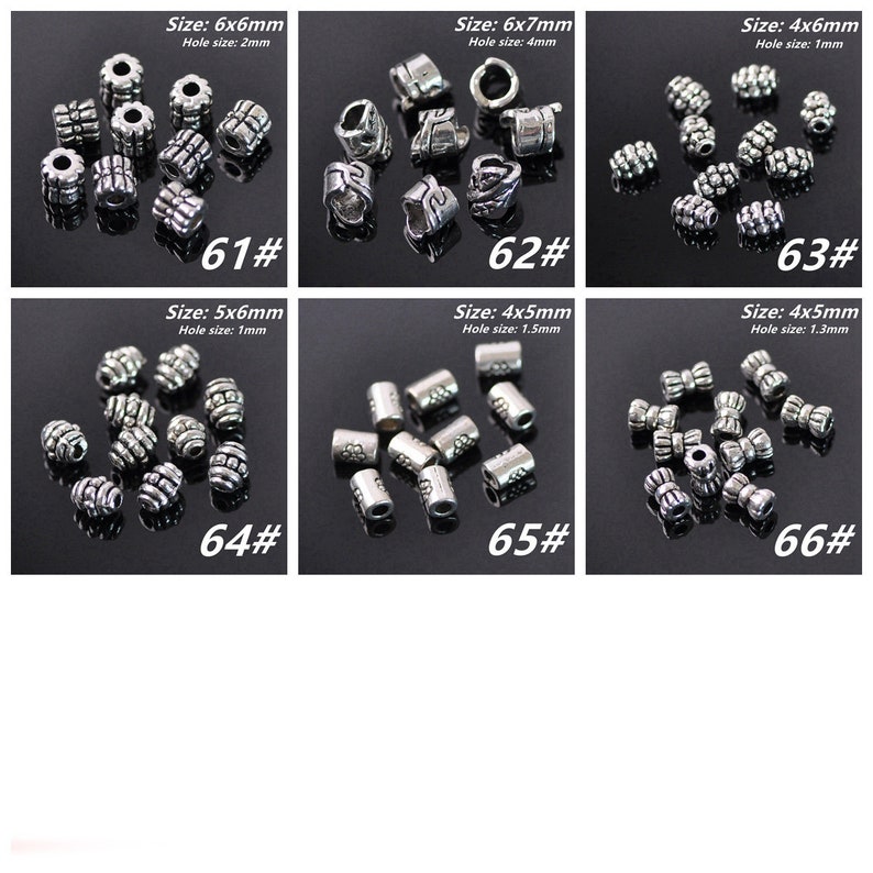 May include: Assortment of silver metal beads in various sizes and styles. The beads are arranged in rows on a black surface. The beads are labelled with their size and hole size in millimetres.  The beads are perfect for jewellery making, crafts, and other projects.