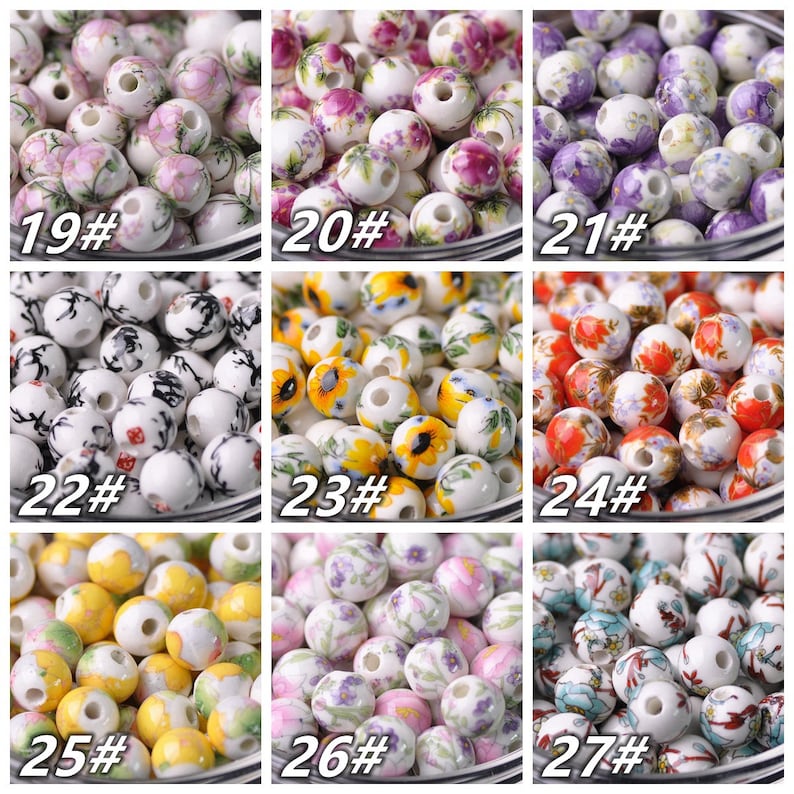 May include: Nine different styles of ceramic beads with various floral and abstract designs. The beads are white with colorful floral patterns. The beads are numbered 19 through 27.