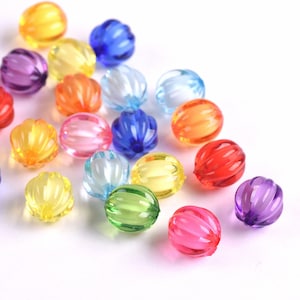 May include: Assortment of colorful, translucent, round beads with a ribbed texture. The beads are made of plastic and are perfect for crafting projects.