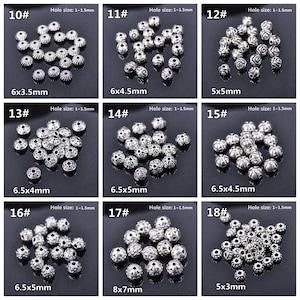 May include: Assortment of 18 silver metal beads with different sizes and designs. The beads have a hole size of 1-1.5 mm. The beads are arranged in rows of three, with each row labelled with a number from 10 to 18. The beads are all silver in colour and have a variety of designs, including floral, geometric, and abstract patterns.